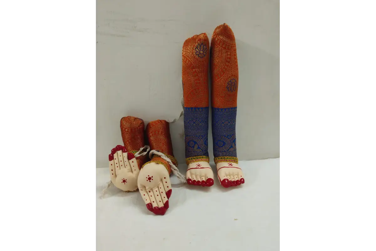 Decorative items resembling feet and hands with colorful patterns on a white surface.