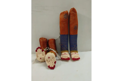 Decorative items resembling feet and hands with colorful patterns on a white surface.