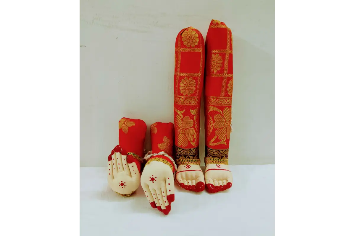 Set of red and gold traditional baby shoes on a white background