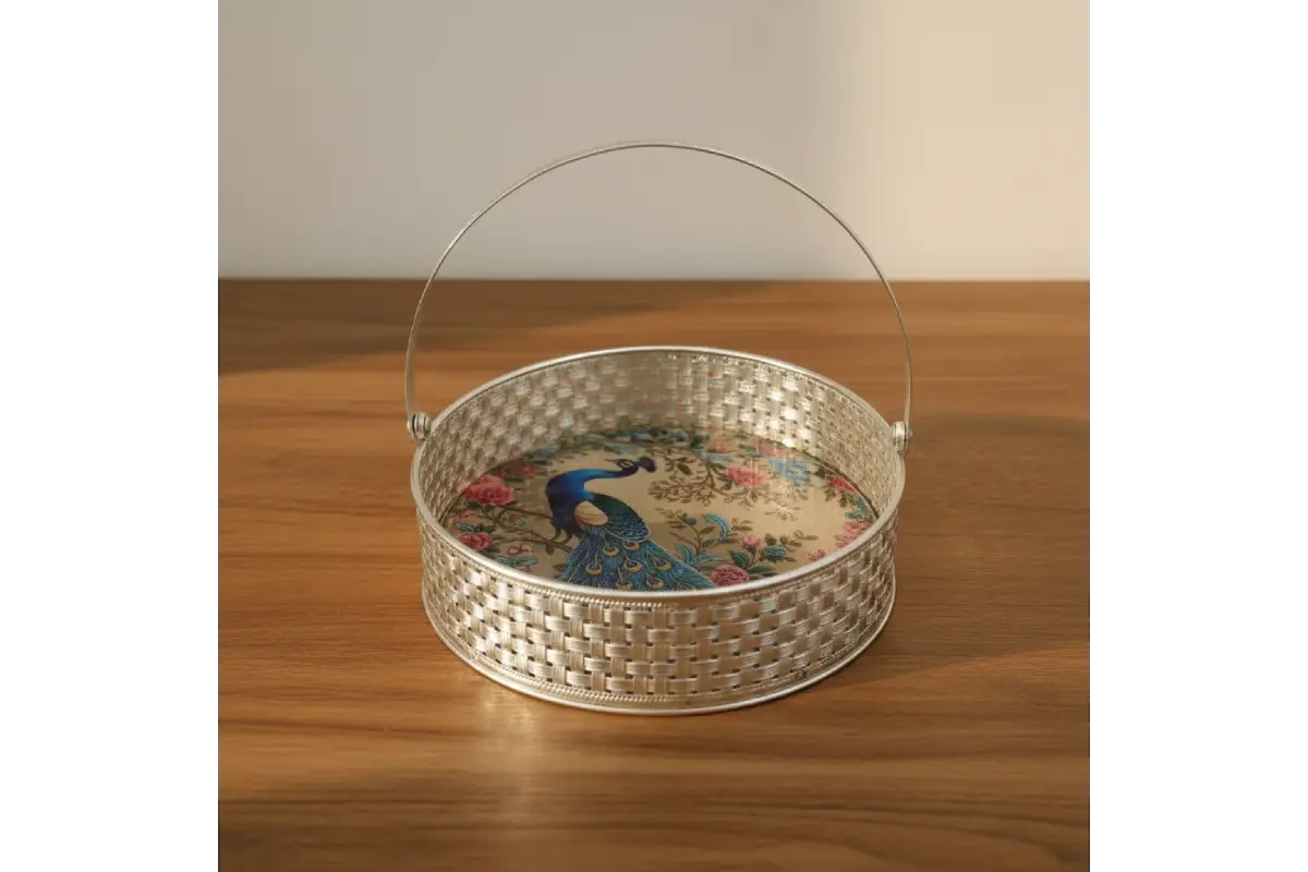 Decorative metal basket with a handle on a wooden surface