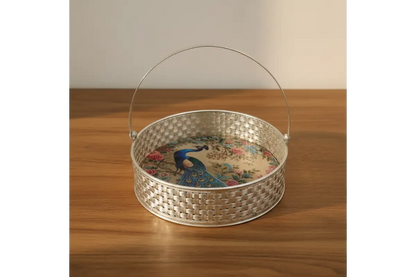 Decorative metal basket with a handle on a wooden surface