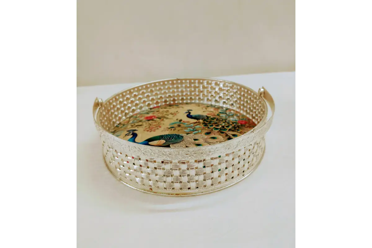Decorative woven tray with peacock design on a white surface