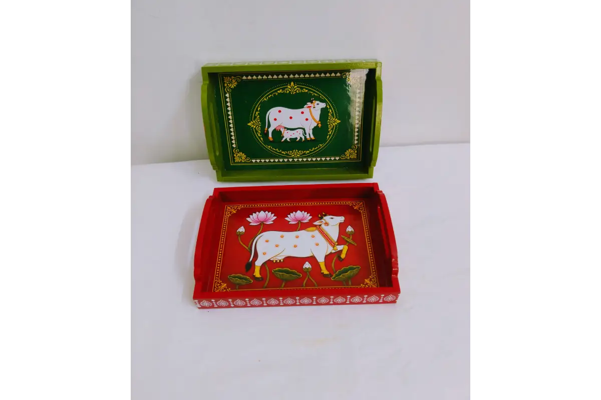 Close-up view of traditional Pichwai cow and lotus print with glossy finish on wooden tray