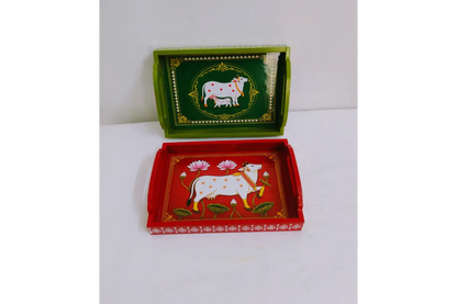 Close-up view of traditional Pichwai cow and lotus print with glossy finish on wooden tray