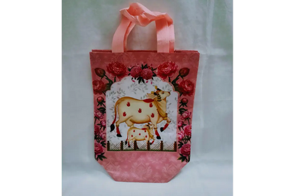 Close-up view of vibrant Pichwai lotus and cow artwork printed on durable return gift bag