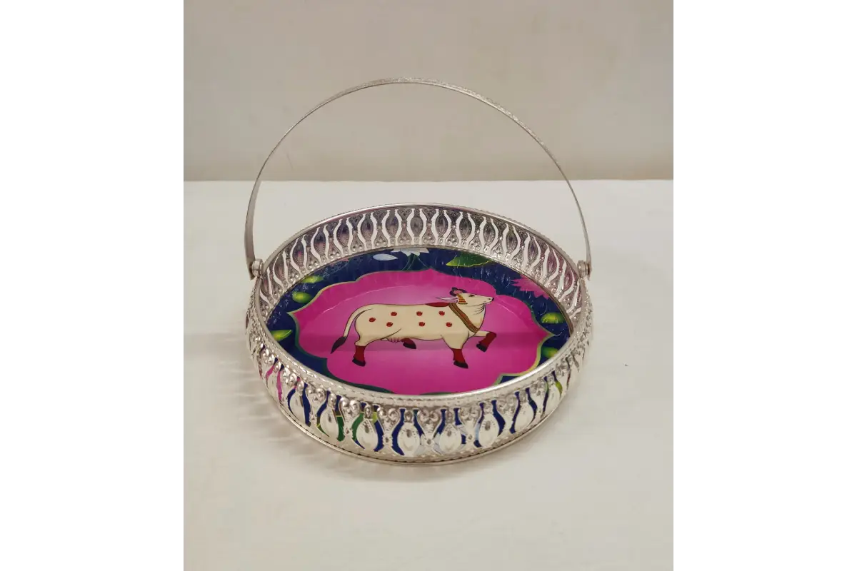 Decorative metal basket with a cow design on a white background