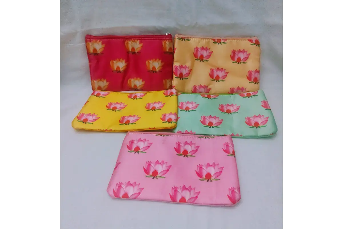 Soft pink satin zipper pouch printed with lotus motifs for Varalakshmi return gifts