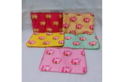 Soft pink satin zipper pouch printed with lotus motifs for Varalakshmi return gifts