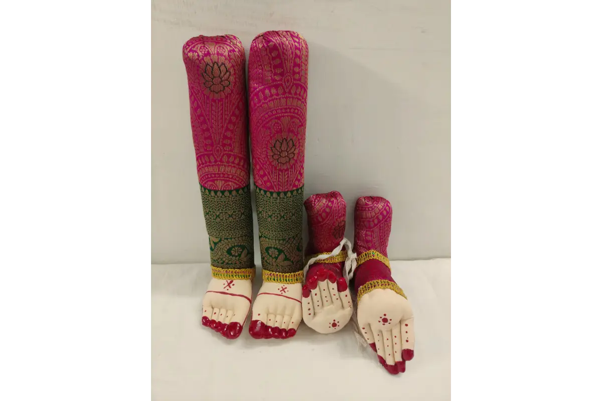 Pair of pink and green footed socks with decorative elements on a white background