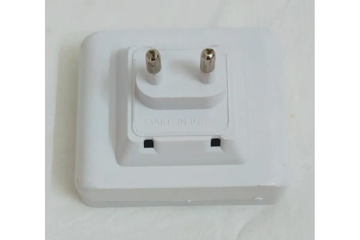 Detail view of two-pin power plug and integrated power switch on LED night lamp base