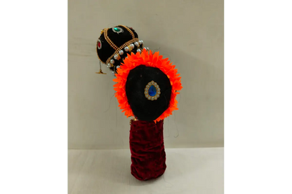 Decorative item with orange and black design on a beige background