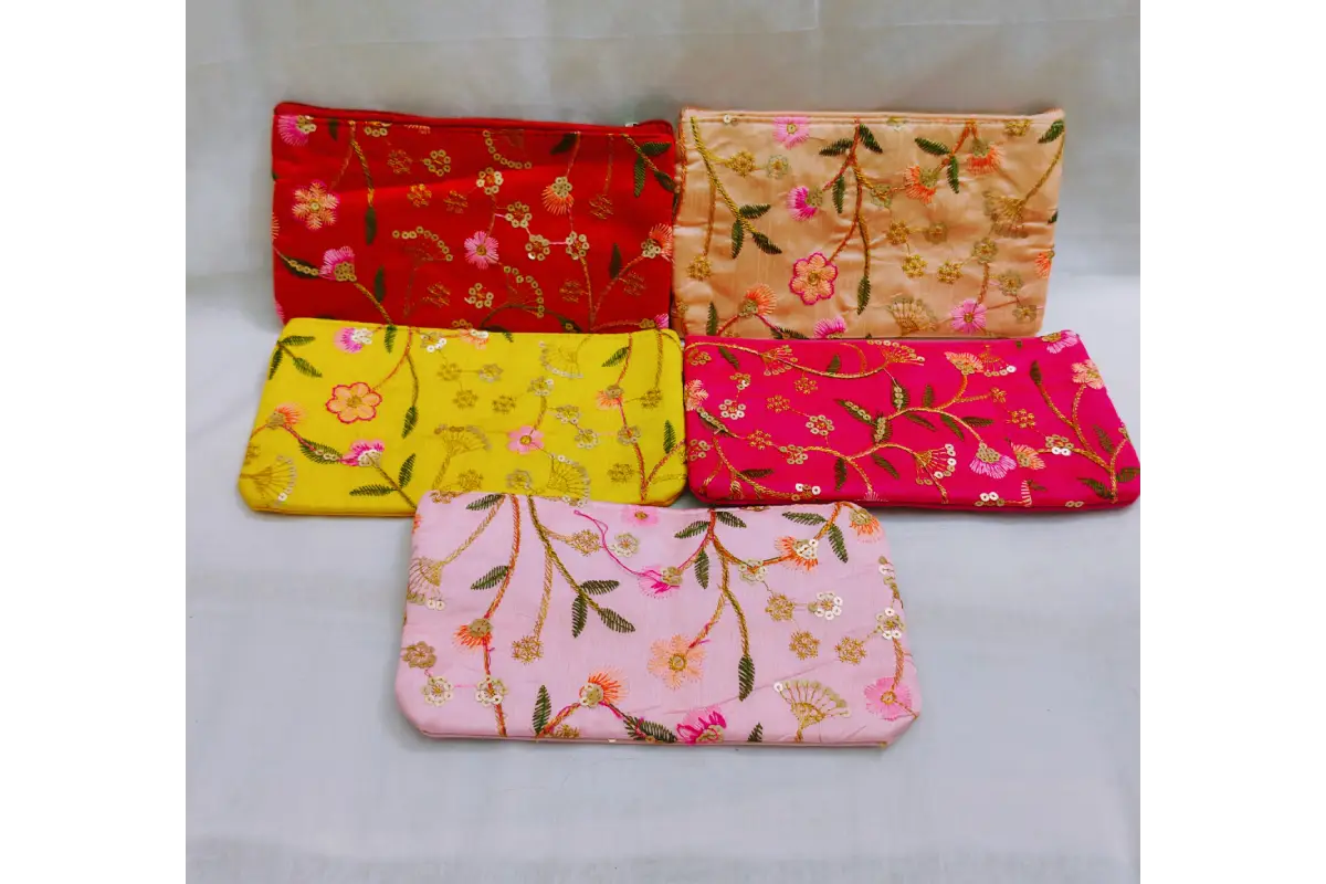 Close-up view of vibrant ethnic print and embroidery threadwork on return gift purse