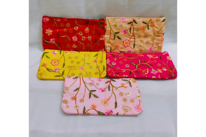 Close-up view of vibrant ethnic print and embroidery threadwork on return gift purse
