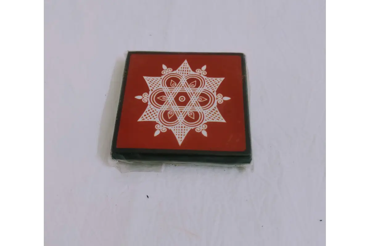 Printed wooden manai patla held in hands showing compact size for return gifting