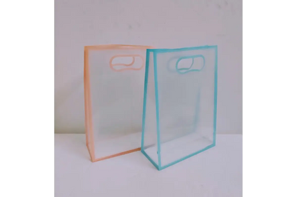 Close-up view of reinforced stitching and durable handle attachment on clear PVC gift bag