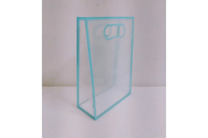 Clear PVC transparent gift bag open and filled with dry fruit jars and thamboolam favors