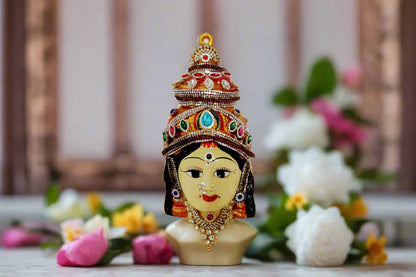 Skin color decorated Varalakshmi face mounted on a Kalasam coconut for traditional home pooja alankaram- Puja Celebrations