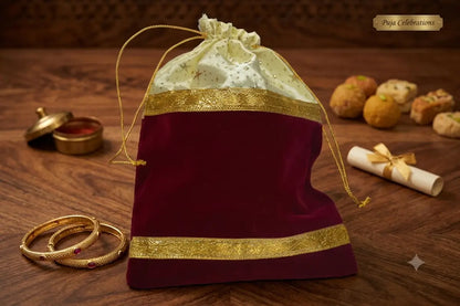 Close-up of a royal red velvet potli bag showing the glossy inner satin lining and gold tassel details - Puja celebrations