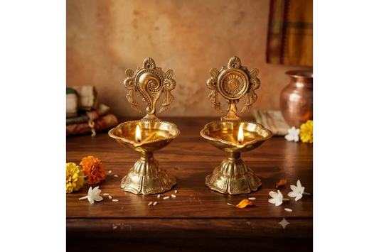Handcrafted brass shankh chakra diya pair for return gifts by Puja Celebrations