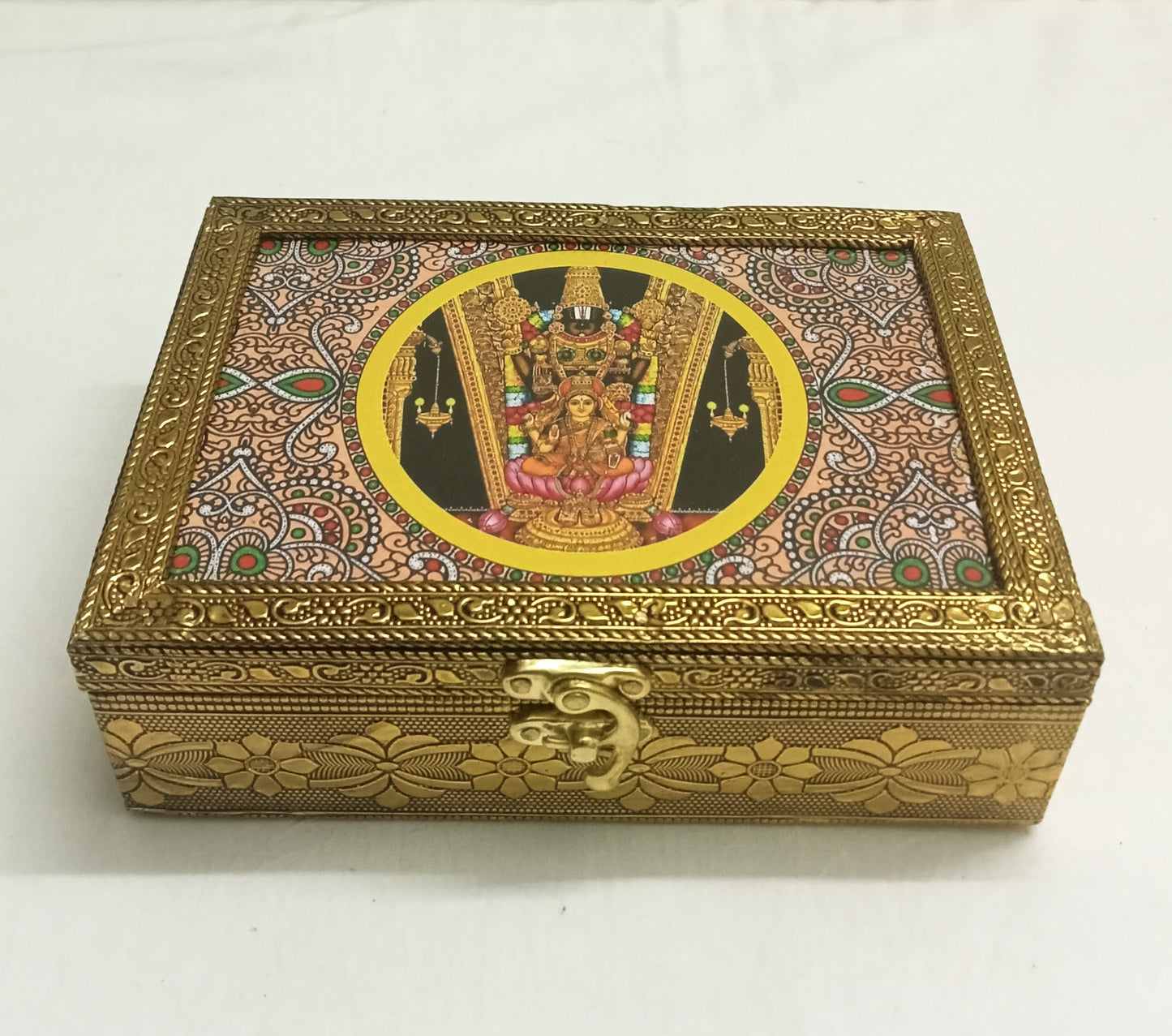 Tanjore print wooden box filled with dry fruits and sweets as an auspicious wedding return gift