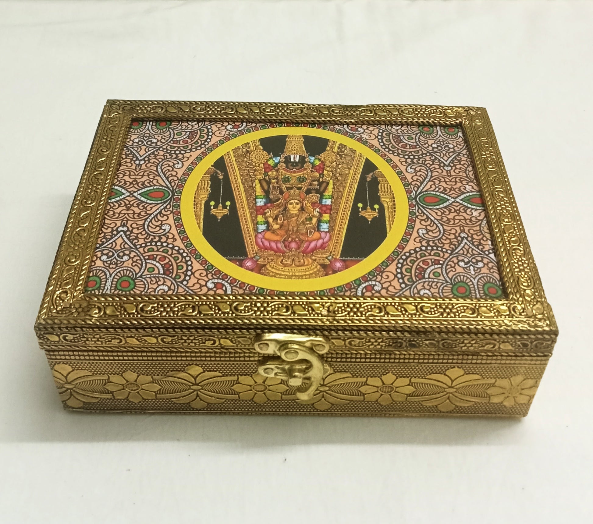 Tanjore print wooden box filled with dry fruits and sweets as an auspicious wedding return gift