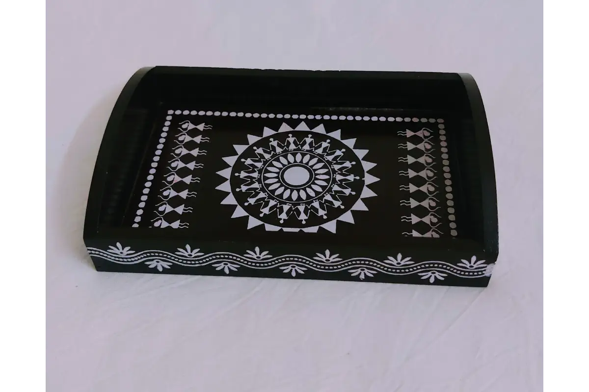 Woman in ethnic silk saree carrying a Warli print wooden thamboolam tray at a function