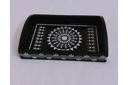 Woman in ethnic silk saree carrying a Warli print wooden thamboolam tray at a function