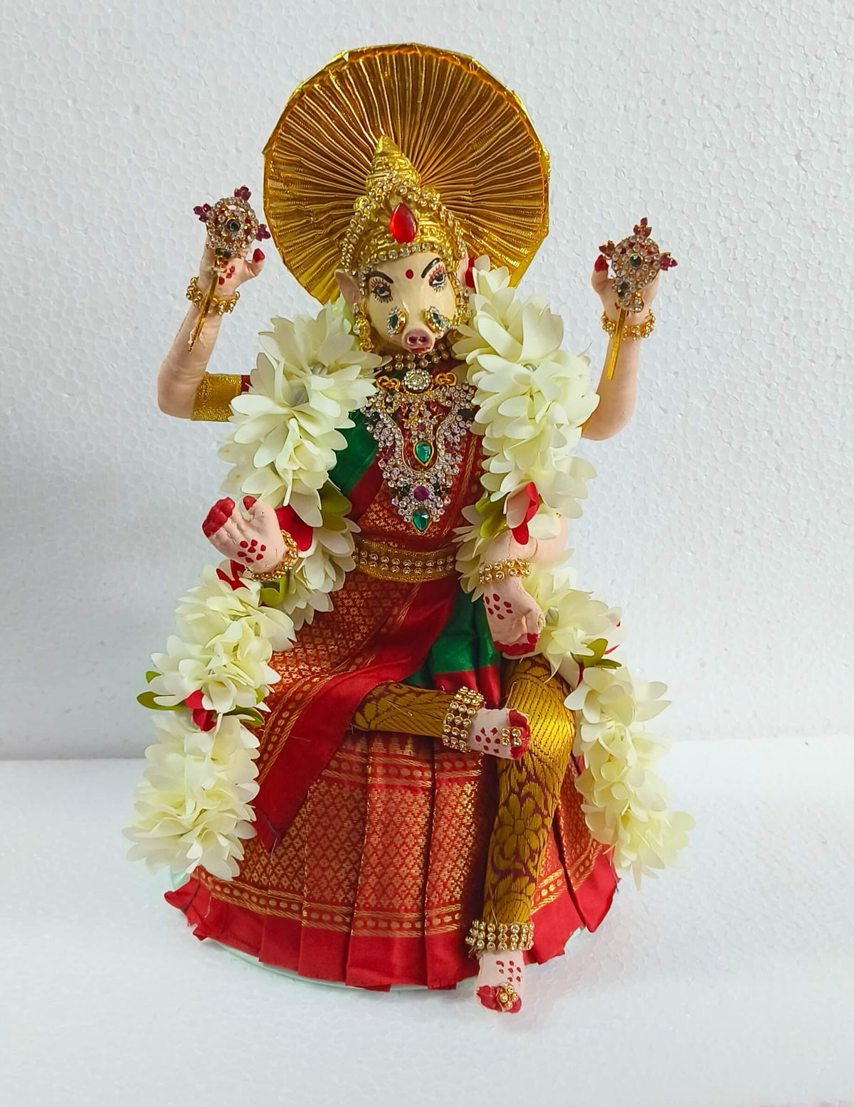 Decorated Varahi Devi idol placed gracefully on a wooden multi-tier Golu stand for festival decor- Puja Celebrations