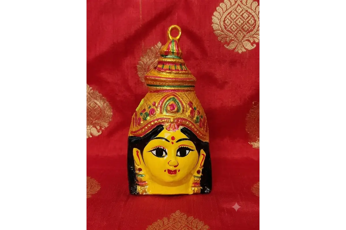 Intricate facial features of yellow Lakshmi Amman mugam idol mask for Varalakshmi Vratham