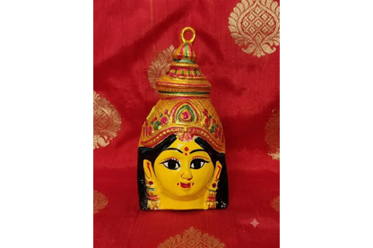 Intricate facial features of yellow Lakshmi Amman mugam idol mask for Varalakshmi Vratham
