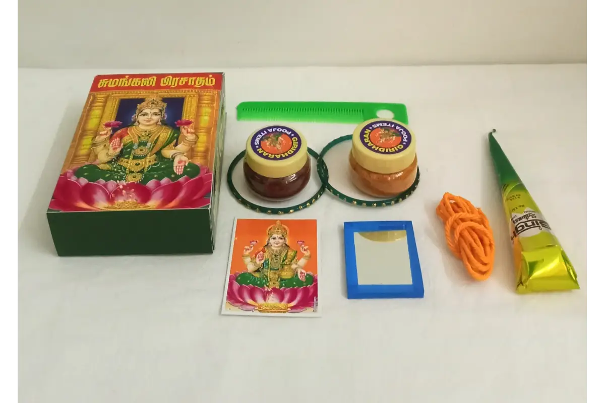 Thamboolam Sumangali return gift set placed beside a decorated Varalakshmi Amman Kalasam