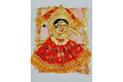 Decorative item with a face design in a gold and red frame on a white background