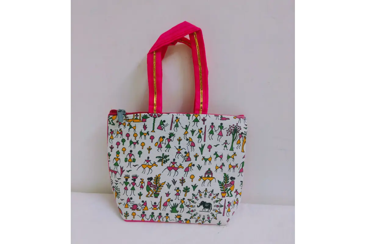 Close-up shot of white Warli tribal figure print on dark fabric handbag