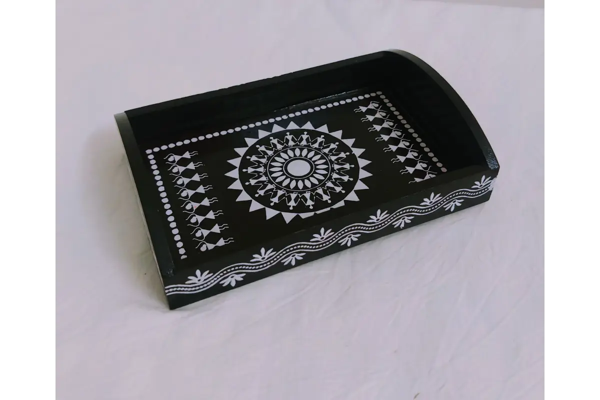 Wooden Warli print return gift tray placed near Navaratri Golu stand and marigold decor