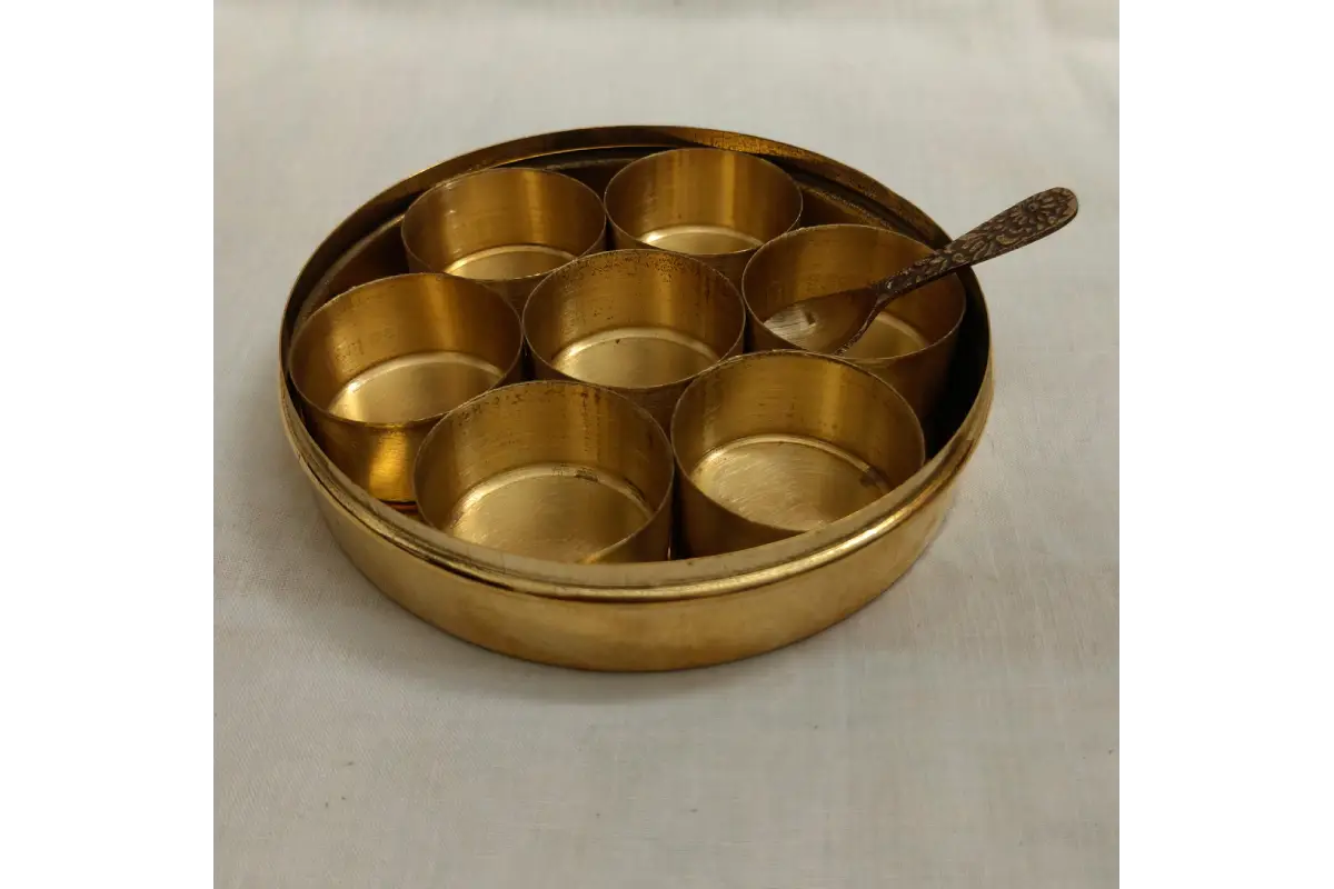 Bulk stock of traditional brass masala boxes Anjarai Petti packed for wholesale return gift orders at Puja Celebrations