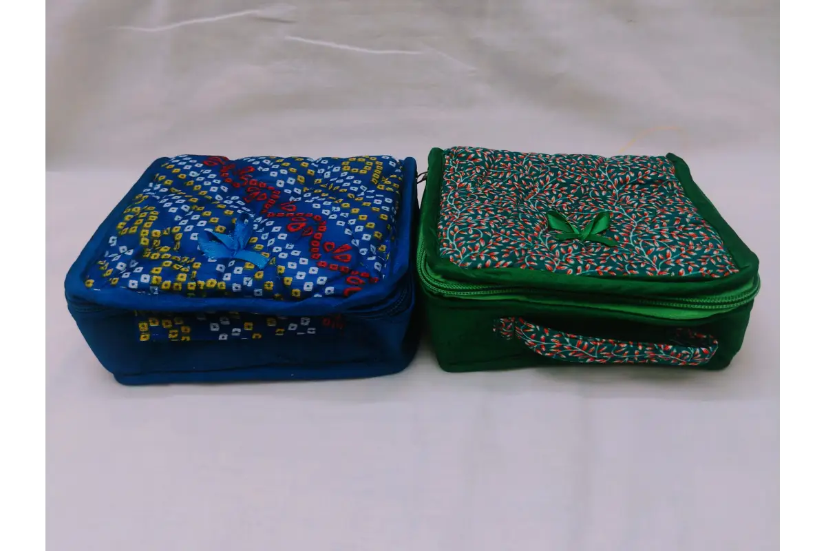 Assorted multi-colored designer fabric jewels pouches available in bulk wholesale at Puja Celebrations