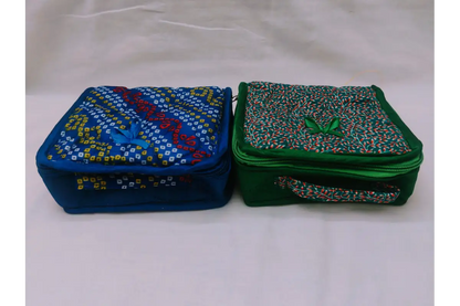 Assorted multi-colored designer fabric jewels pouches available in bulk wholesale at Puja Celebrations