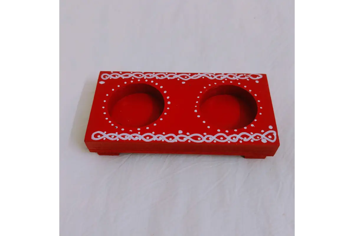Lit traditional brass oil lamp resting securely on a polished wooden diya holder base