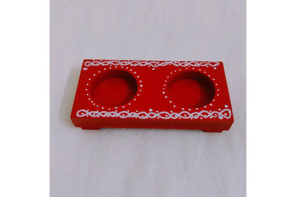Lit traditional brass oil lamp resting securely on a polished wooden diya holder base