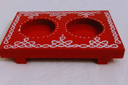 Wooden diya holder placed near Navaratri Golu display stand and marigold garlands