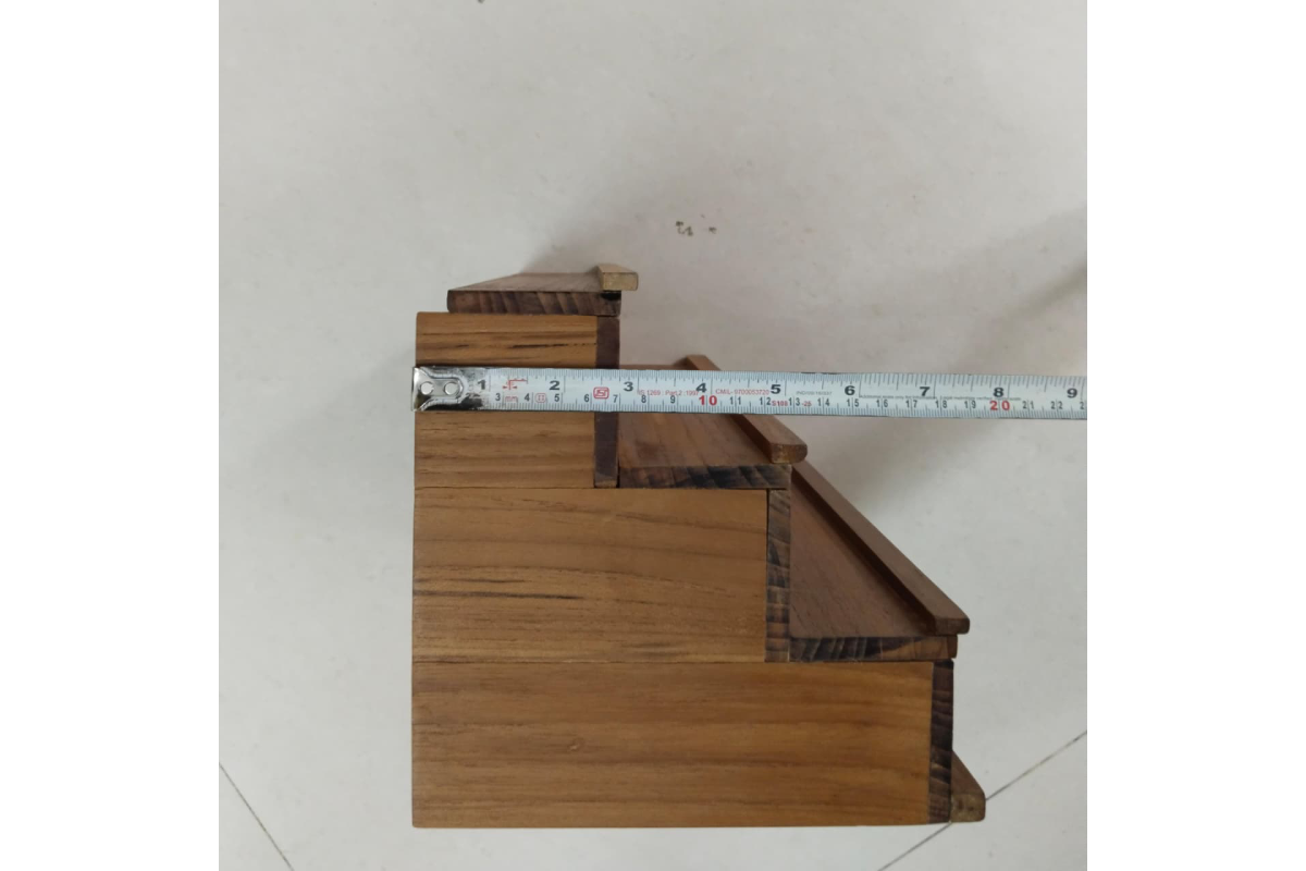 Close-up view of precision slot locking mechanism on wooden golu stand