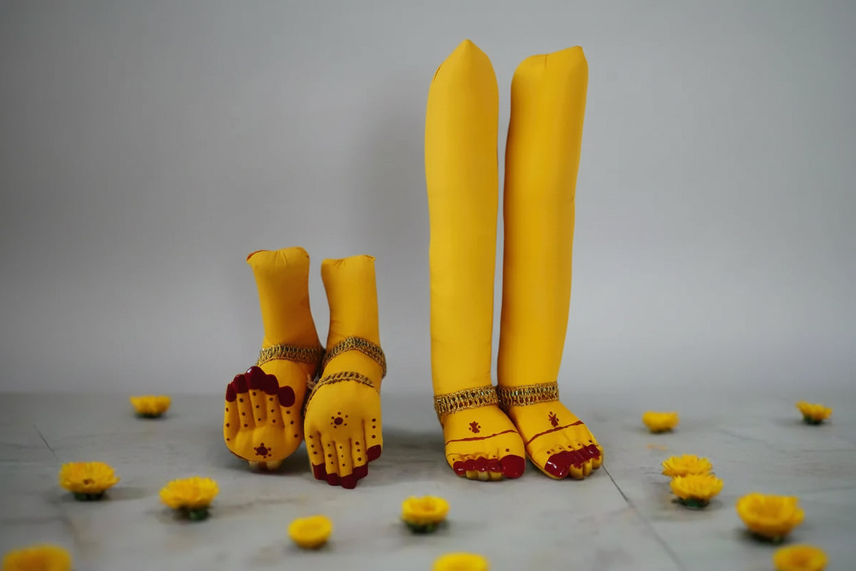 Traditional stuffed yellow fabric deity hands and legs pinned onto a draped silk saree for Varalakshmi Viratam